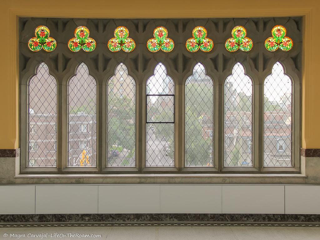 Row of narrow windows crowned with stained glass