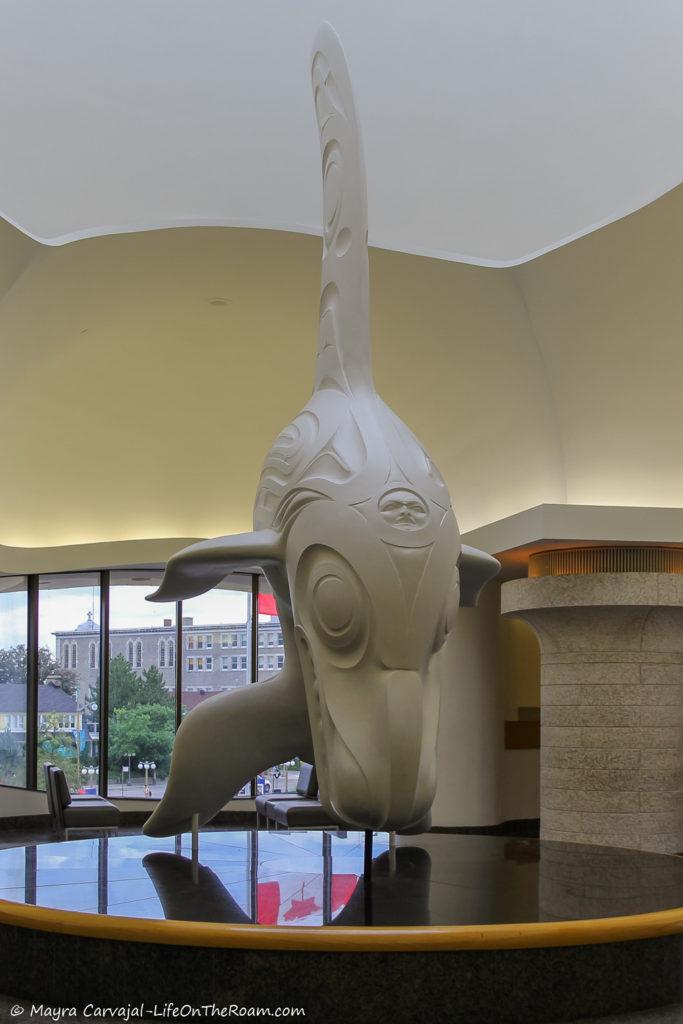 A sculpture of a marine mammal by an Indigenous artist