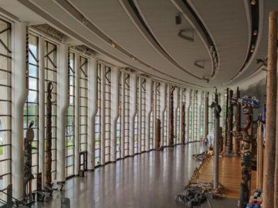 View of a gallery with a glass enclosure and totem poles