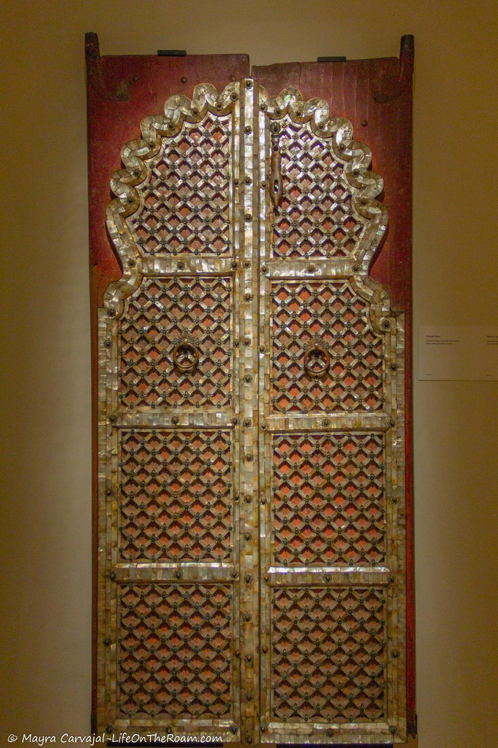 A pair of ancient wood carved double door heavily ornated