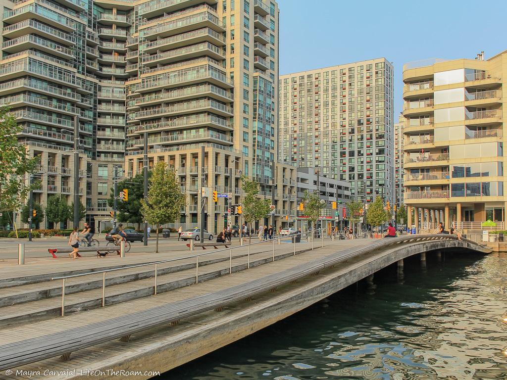 A waving deck on the water in an urban setting