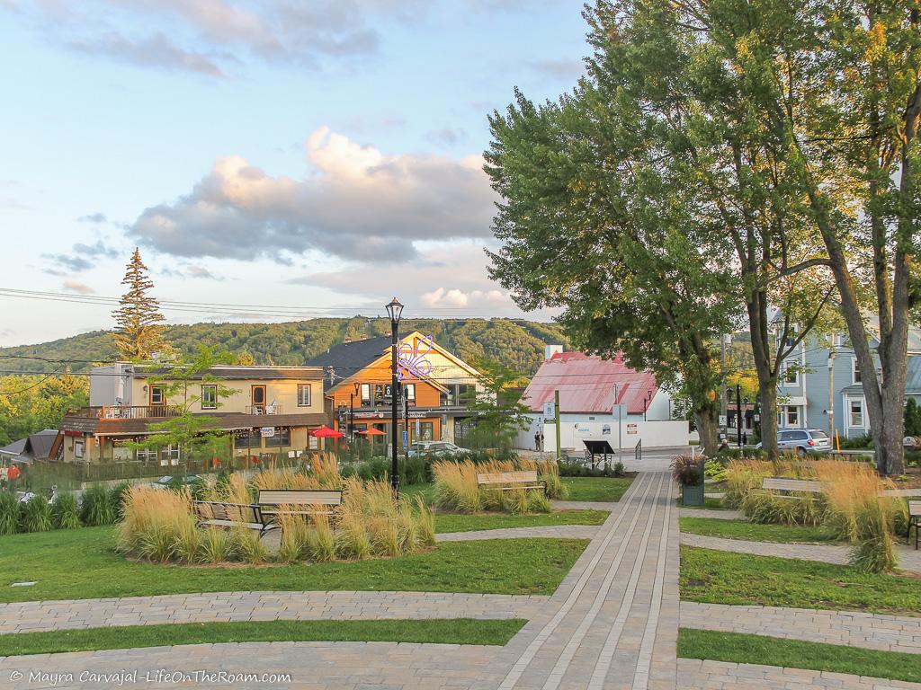 A square with small buildings and mountains in the background