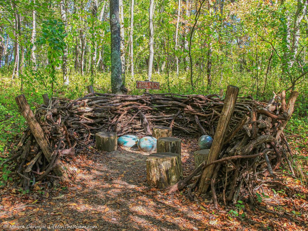 An outdoor sculpture resembling a nest in the forest