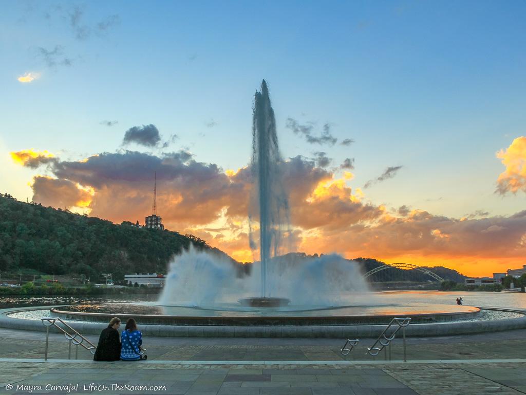 A circular fountain against the sunset
