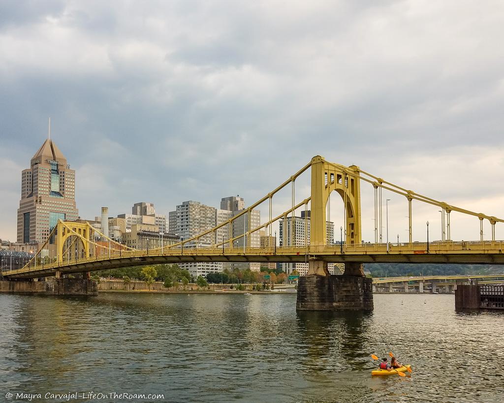 A kayak near a bridge on a river