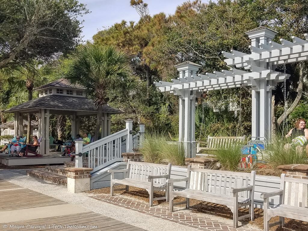 A public boardwalk with swings and benches