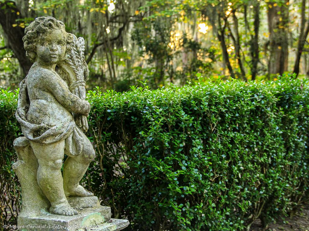 A small statue in a formal garden