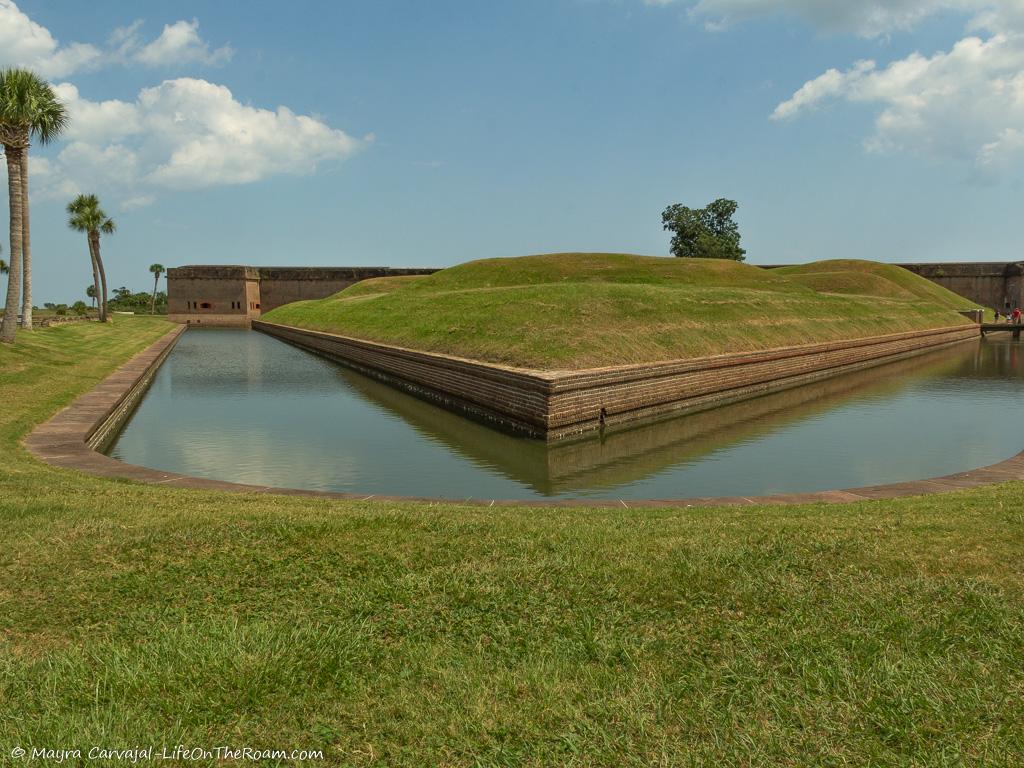 Earthen mounds surrounded by a moat