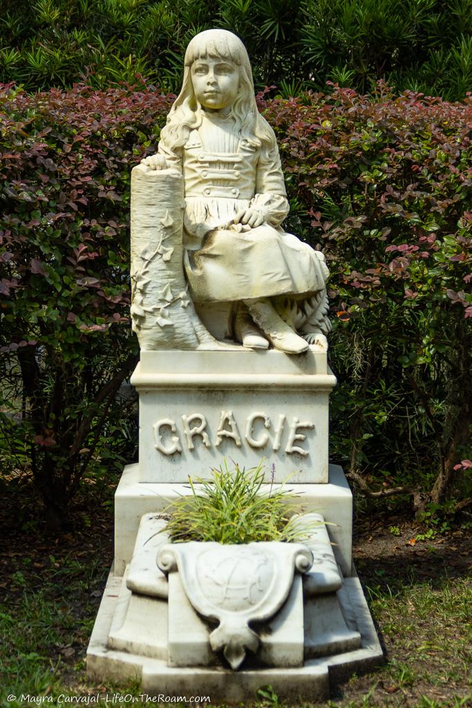 A statue of a girl in a cemetery