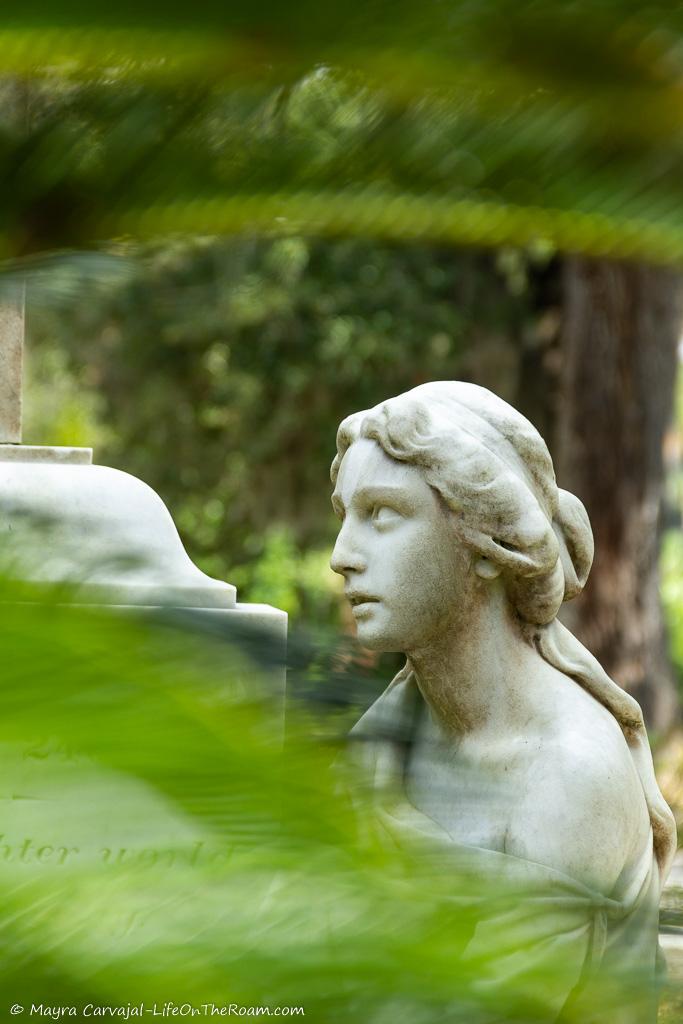 A statue of a woman in a cemetery