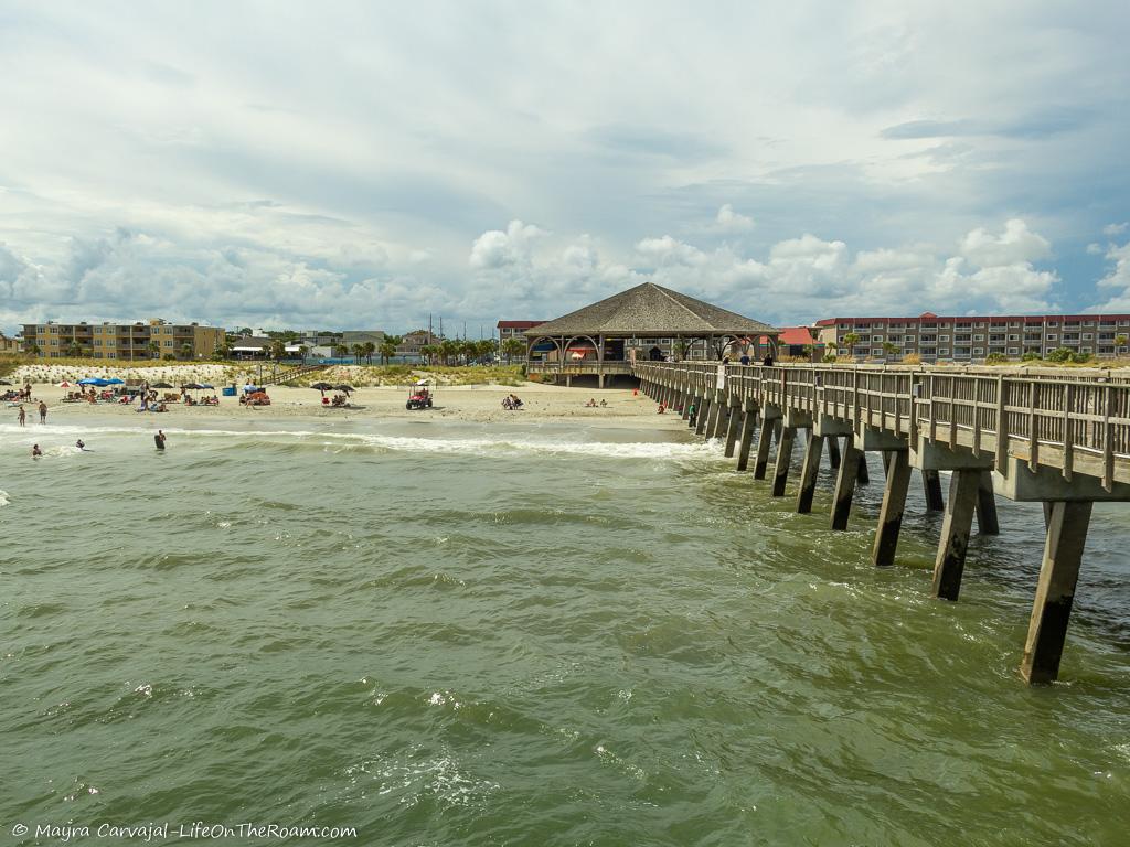 A long and tall pier on a beach