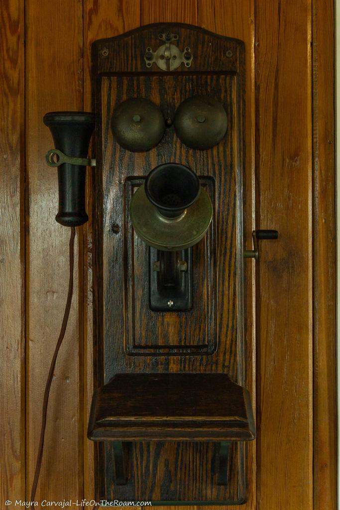 A wall-mounted antique phone