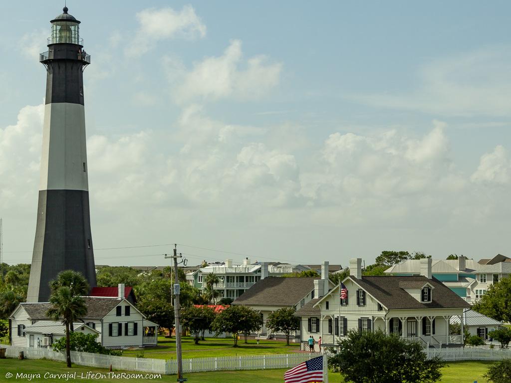 A lighthouse with historic houses