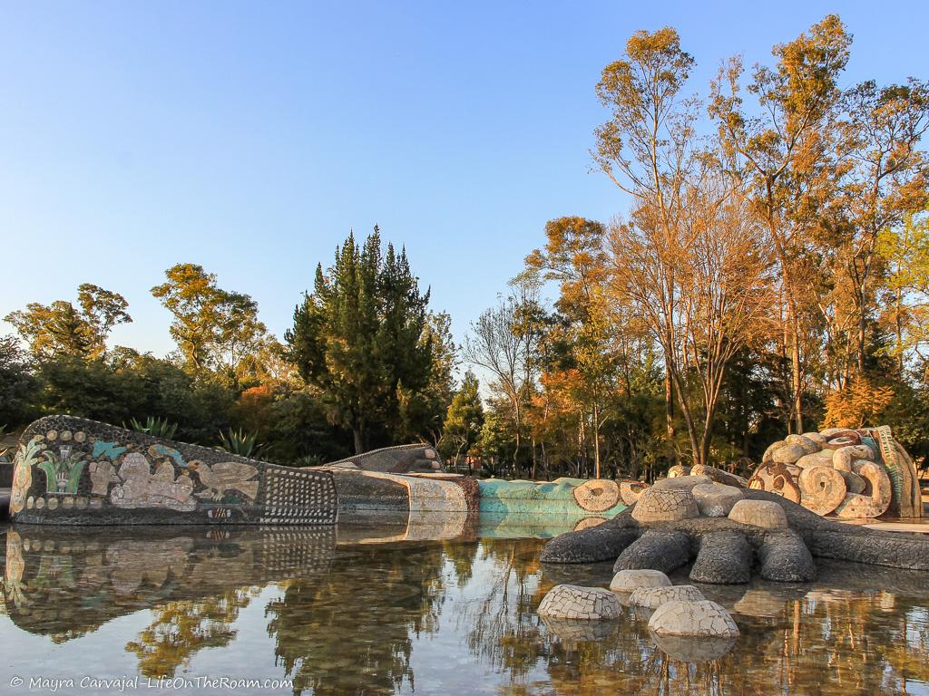 A fountain with a sculpture, in a park