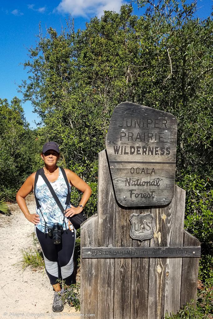 Mayra standing next to the Juniper Wilderness trail sign