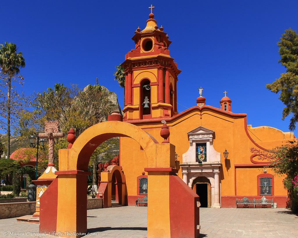 A colonial church with orange and burnt red colours