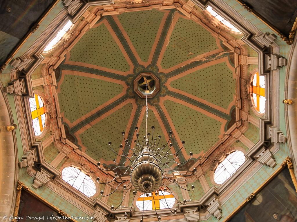 The dome of a church with green and pink details