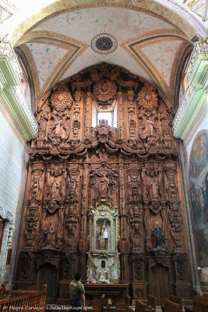 A heavily carved wood altar in a church