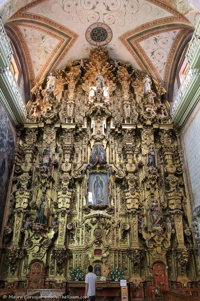 A heavily decorated side altar with details in gold in a church