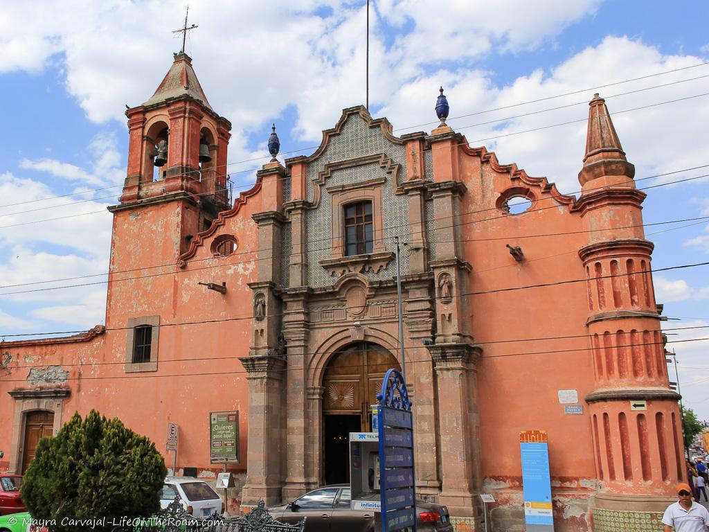 A historic church with a stone façade and glazed tiles