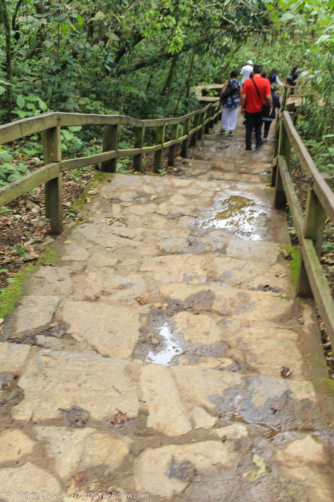 A staircase with people stepping down into a mountain