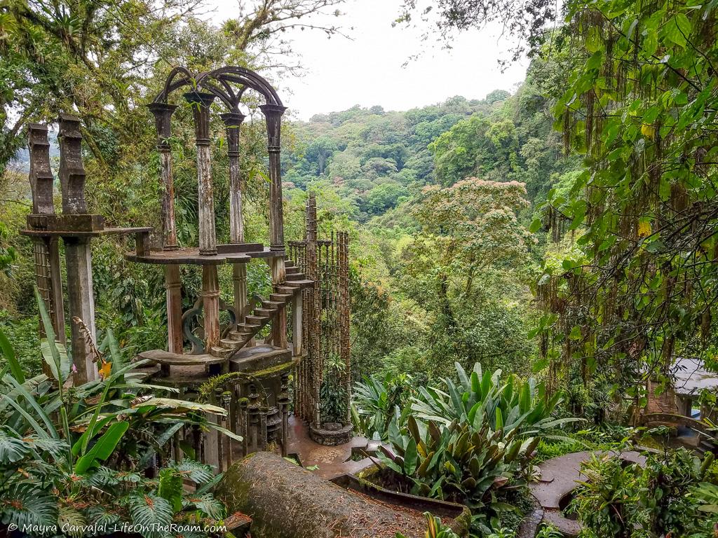 A surrealist looking 2-storey concrete structure in a jungle