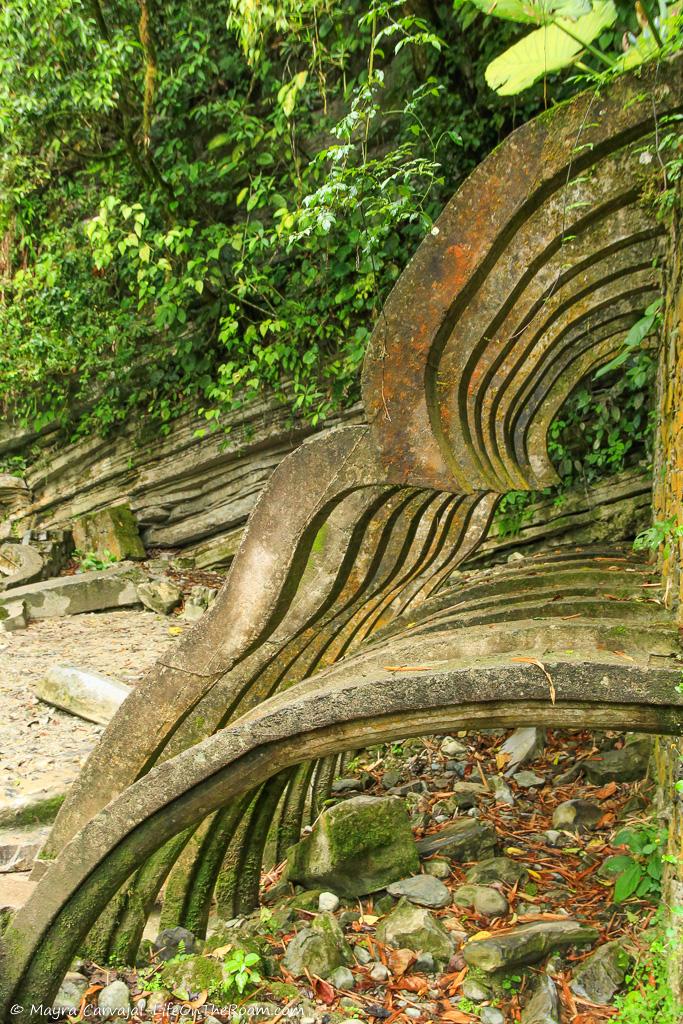 A series of concrete curved arches in a garden