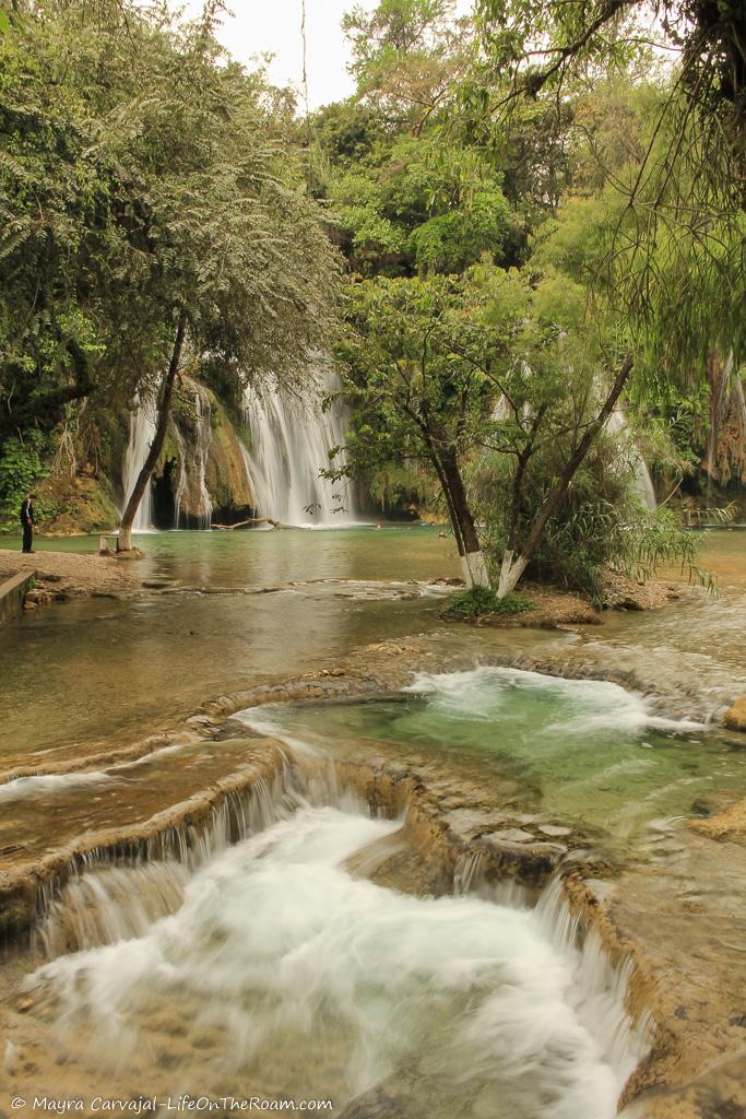 A natural pool with a waterfall