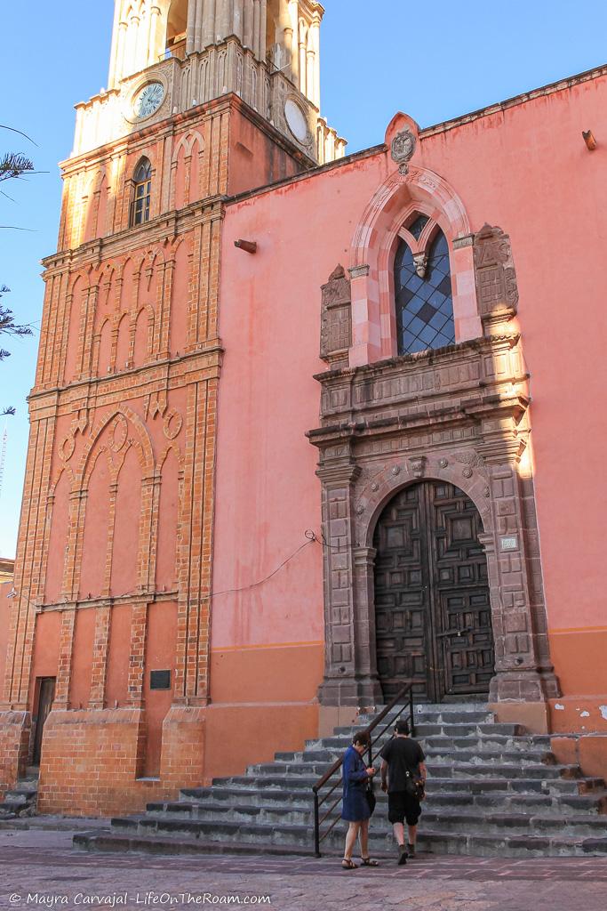 A pink church with a clock tower