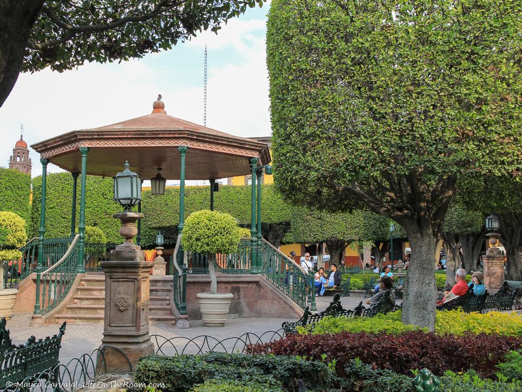 A landscaped square with a gazebo and benches