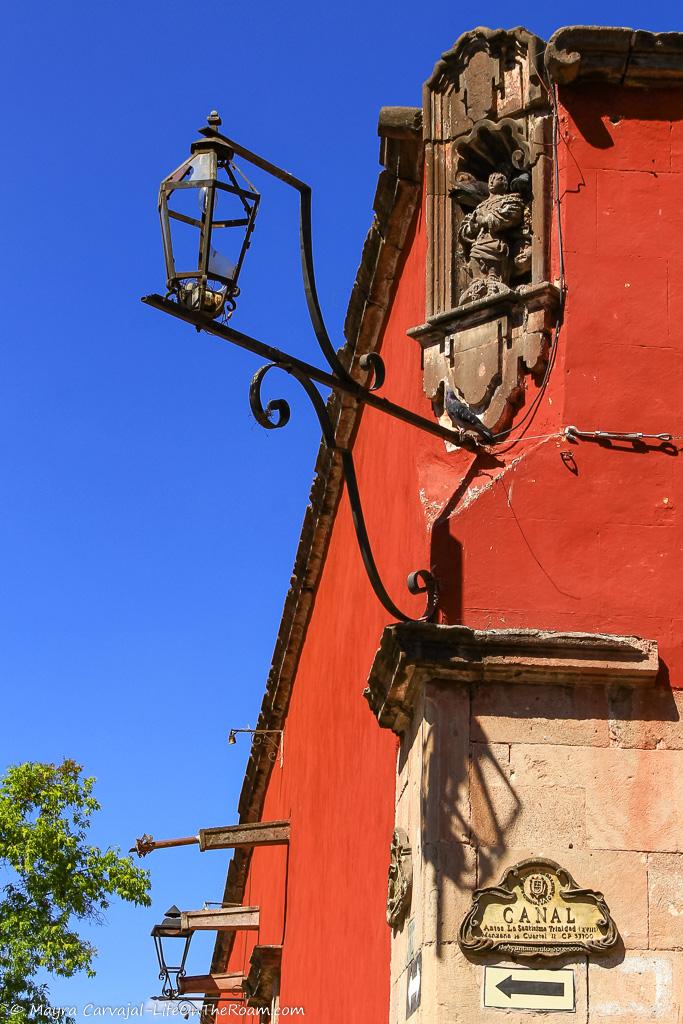 A corner niche in a street with a small statue