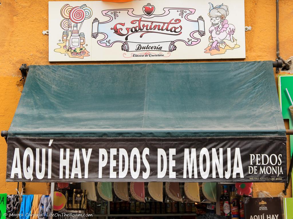 A store sign saying "Aqui hay Pedos de Monja"
