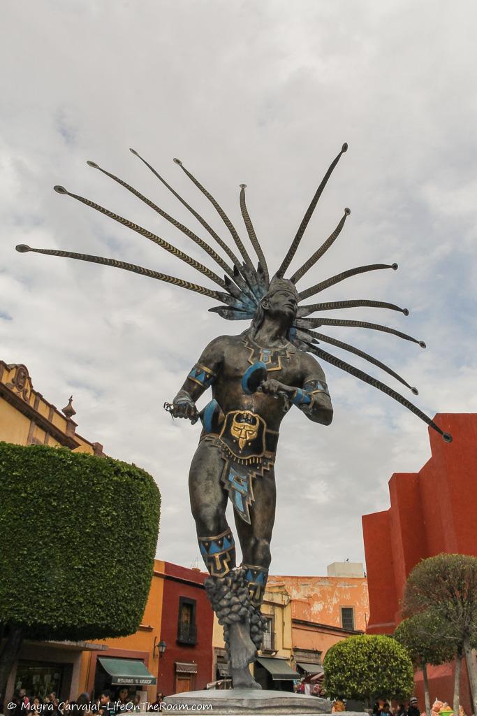 A bronze statue of a dancer in traditional costumes