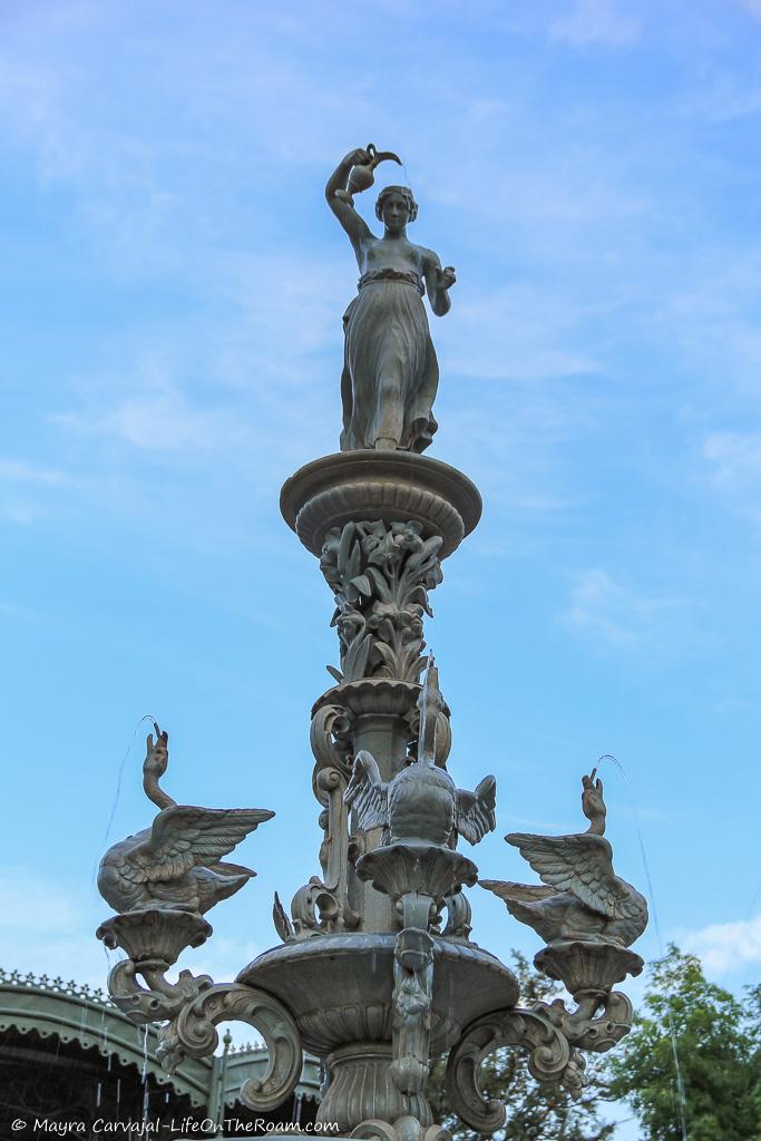 A fountain with a goddess and swans in the centre