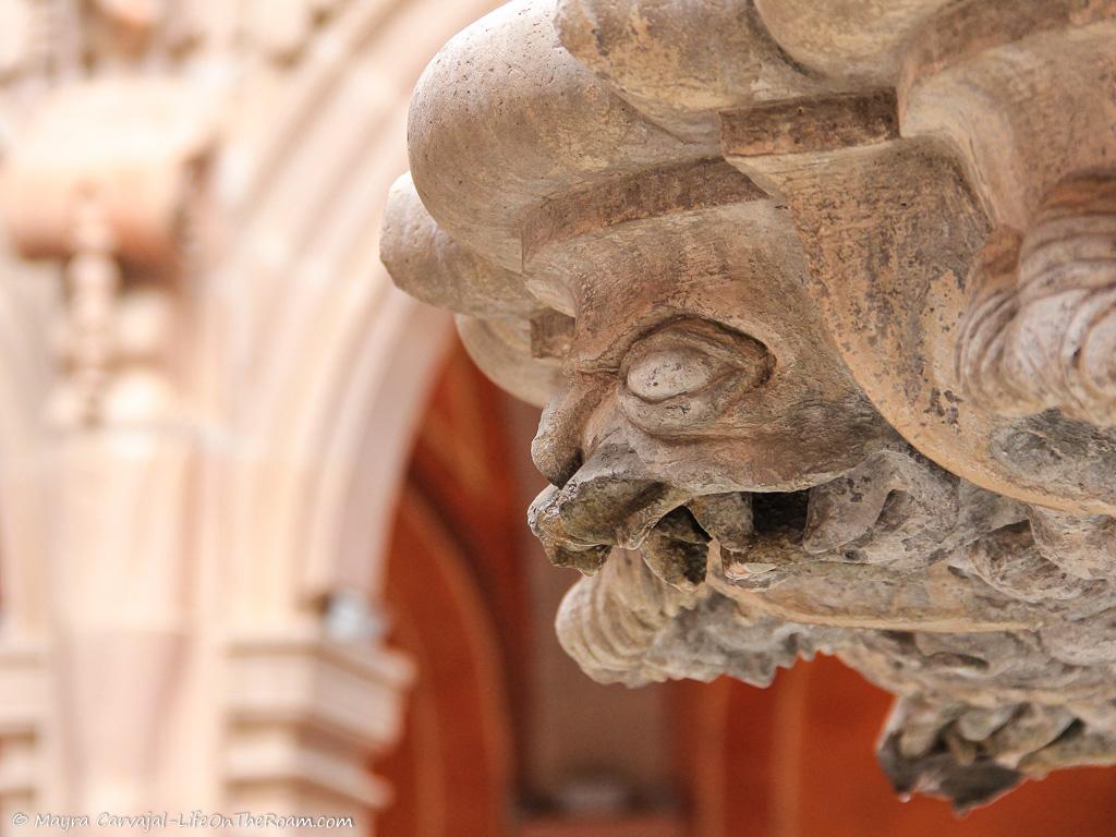 Carving of a fantastic beast adorning a building