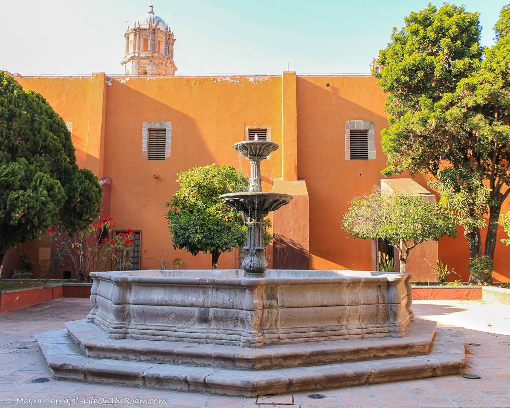 A fountain in an inner patio of a historic building