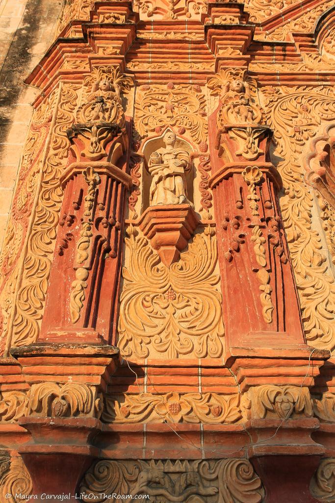 A niche with a statue in an elaborate church façade