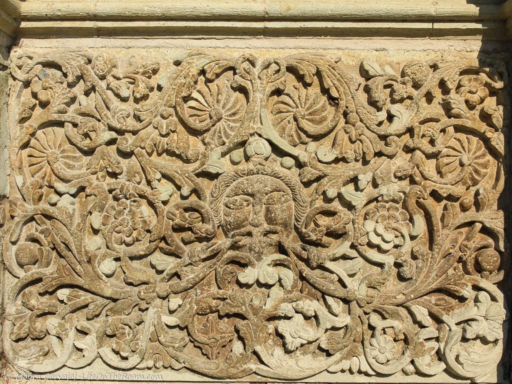 A carved stone flat panel