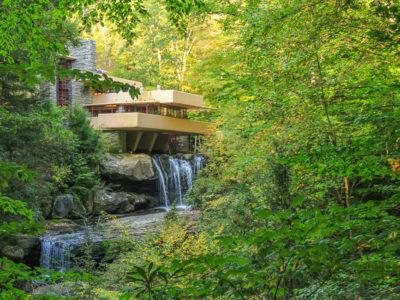 A house in a forest on top of a waterfall