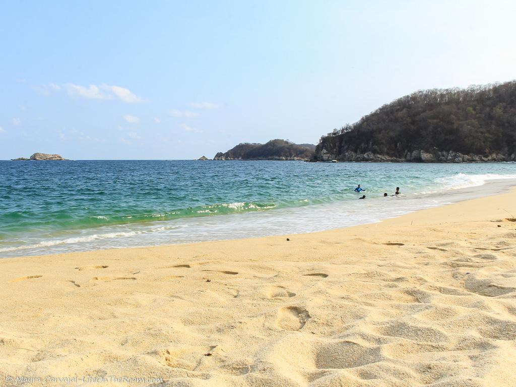 A sandy beach with mountains