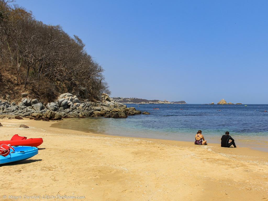 A virgin beach with kayaks on the sand