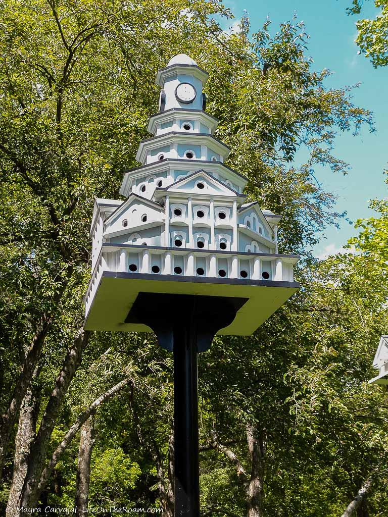 A birdhouse in the shape of a multilevel building