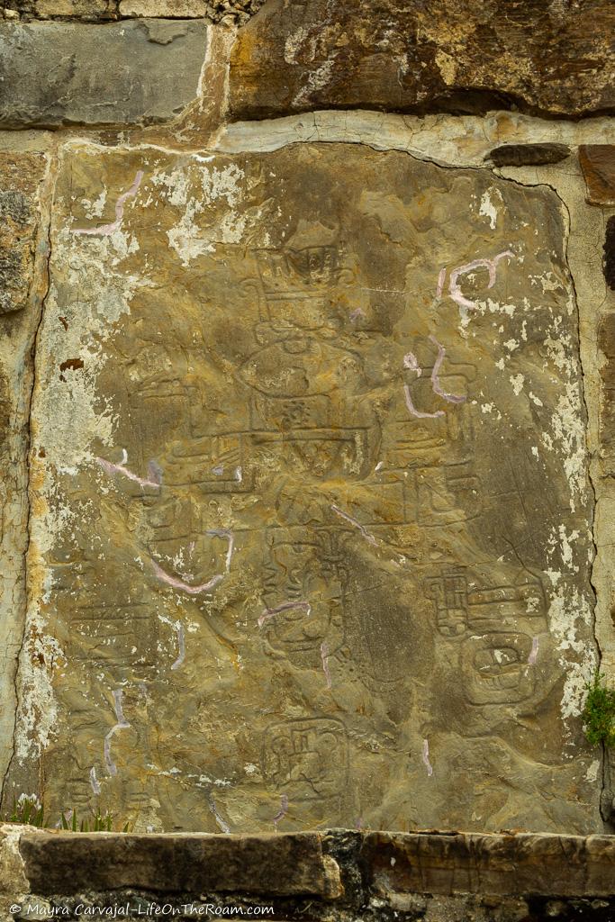 Bas-reliefs in a stone depicting a man upside down