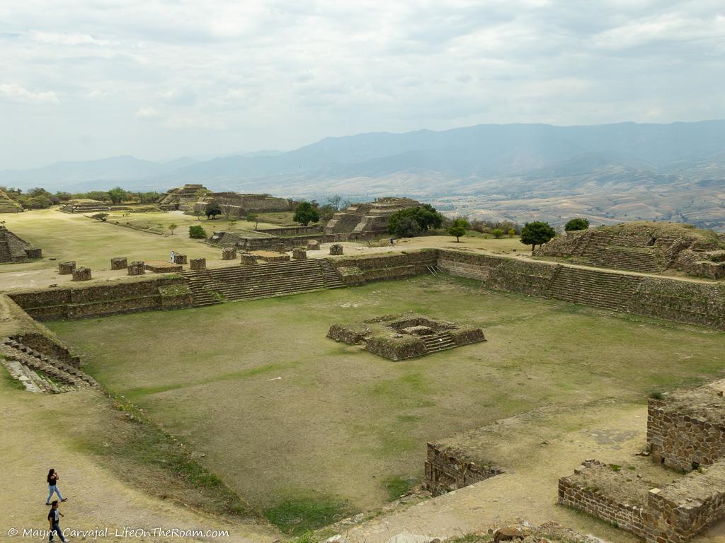 An aerial view of a sunken patio surrounded by ancient temples