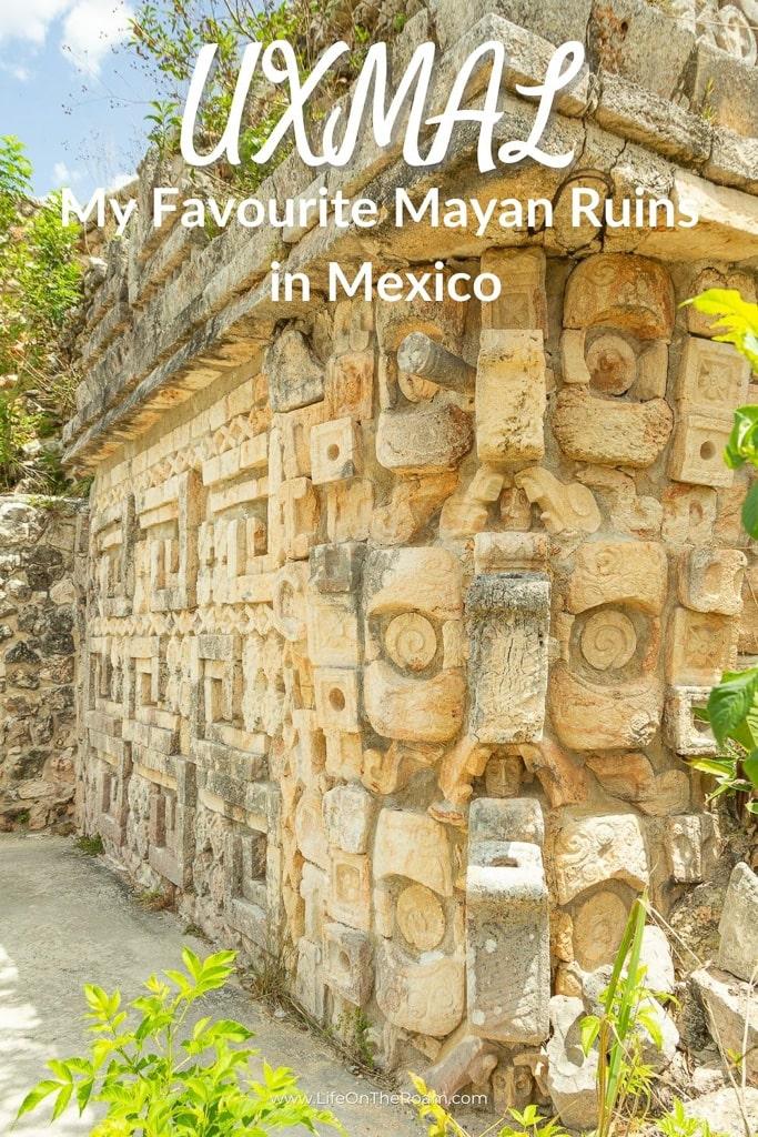 A wall of an ancient Mayan temple covered in masks of the god of rain