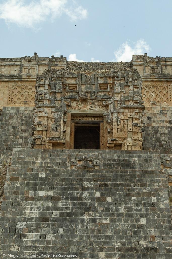 An entrance to a pyramid that is framed by elaborate carvings