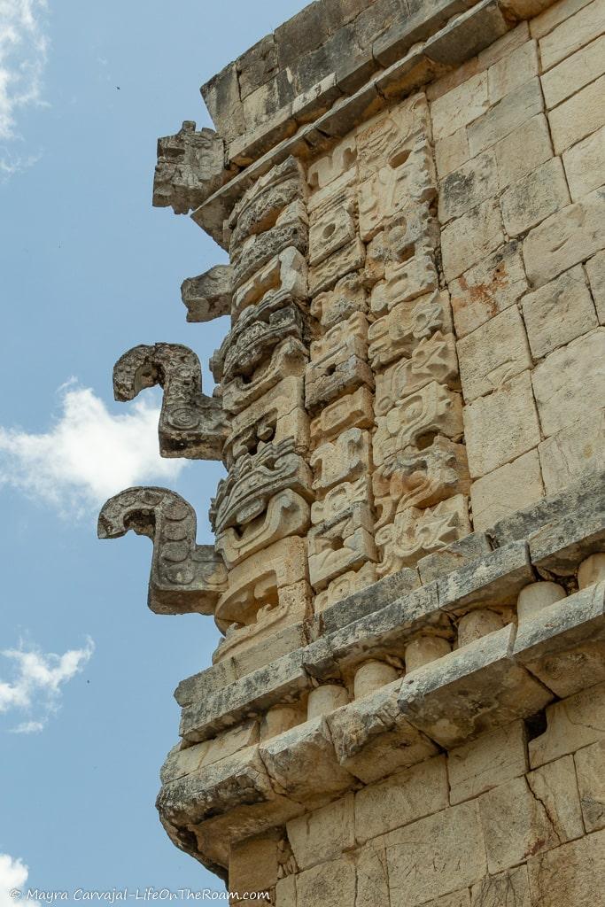 Masks carved in stone in the upper corner of an ancient palace