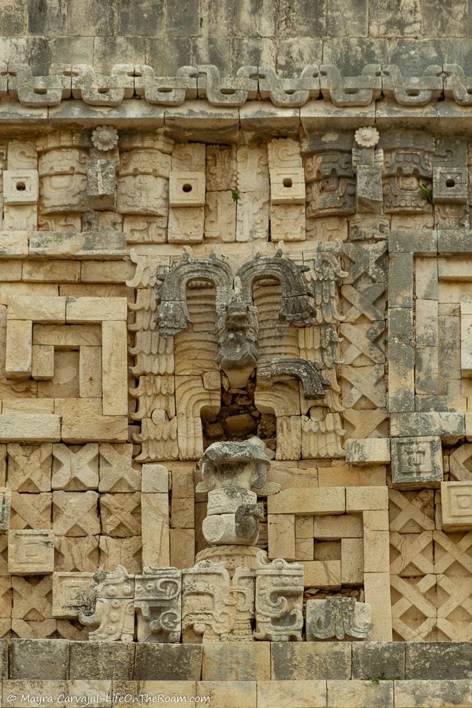 Details of a frieze in an ancient building decorated with masks