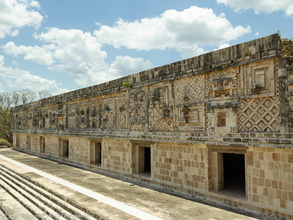 An ancient palace with a frieze decorated with snakes