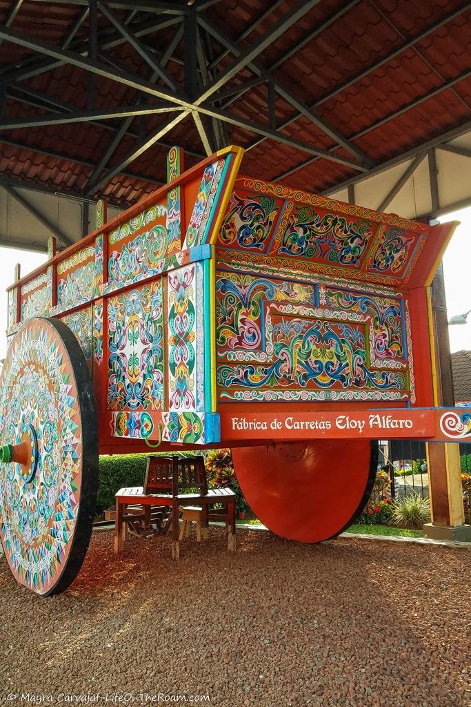 A red orange oxcart with colourful details